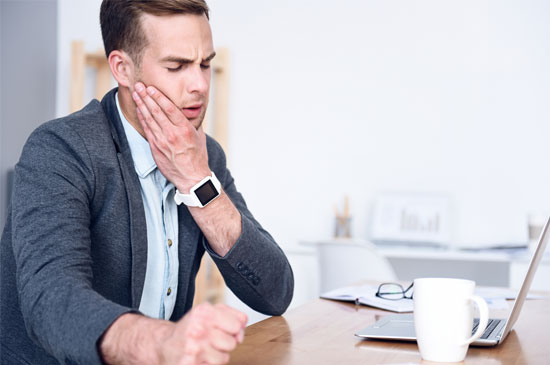 Man Holding jaw in pain