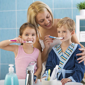 Mother brushing kids teeth